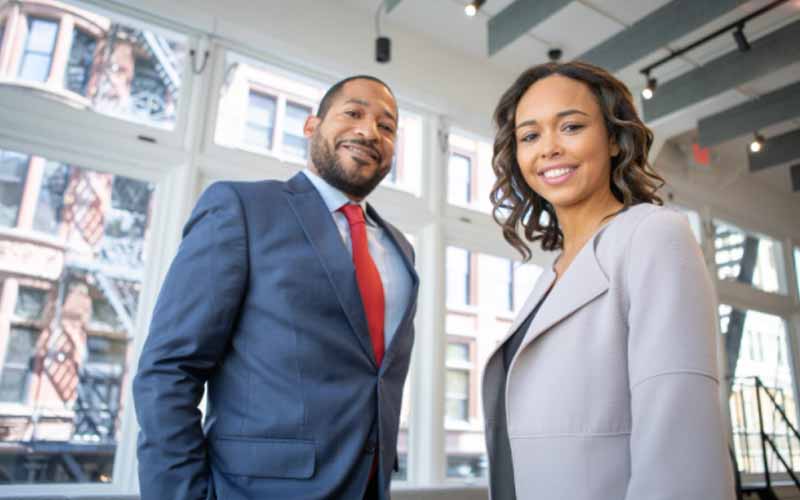 A man and a woman in formal wear smiling