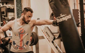 A man punching a bag in a gym