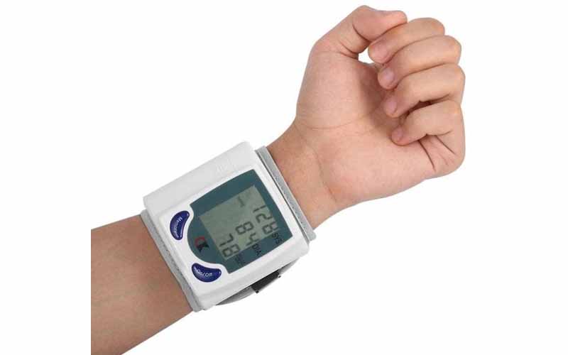 A wrist blood pressure monitor working on a person's wrist