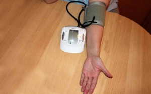 A Working Digital Blood Pressure Monitor on a person's upper arm