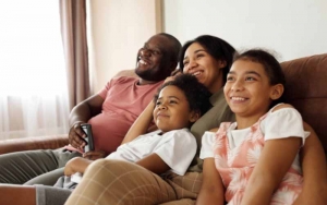 A happy family sitting on a couch