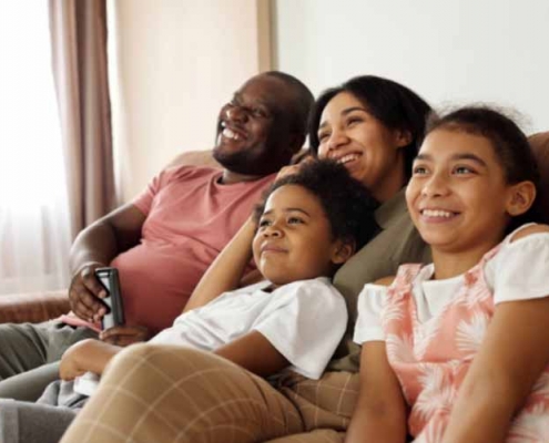 A happy family sitting on a couch