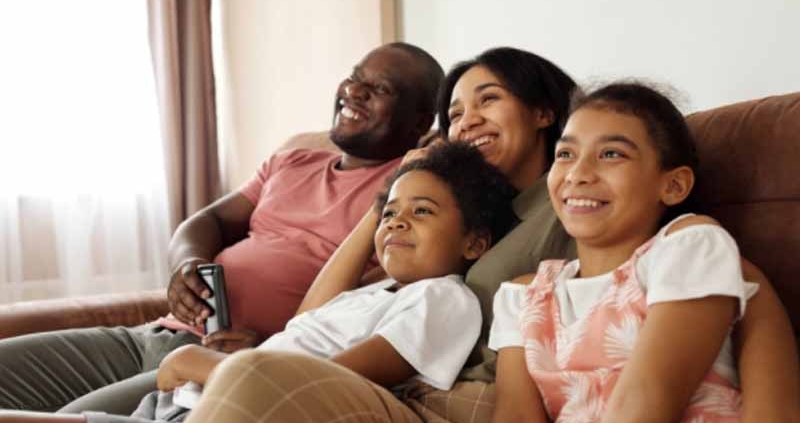 A happy family sitting on a couch