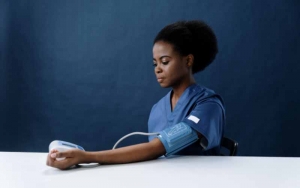 A lady measuring her blood pressure