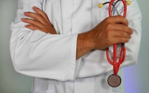 Doctor holding a red stethoscope