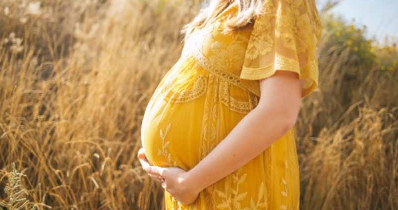 Pregnant woman touching her belly