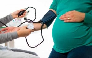 Pregnant lady getting her blood pressure checked.