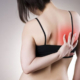 A lady experiencing shoulder blade pain