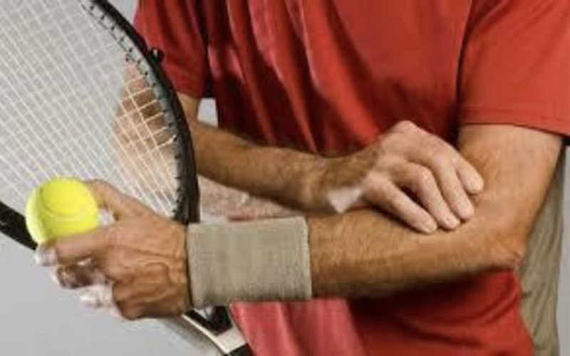 Tennis player experiencing Tennis elbow